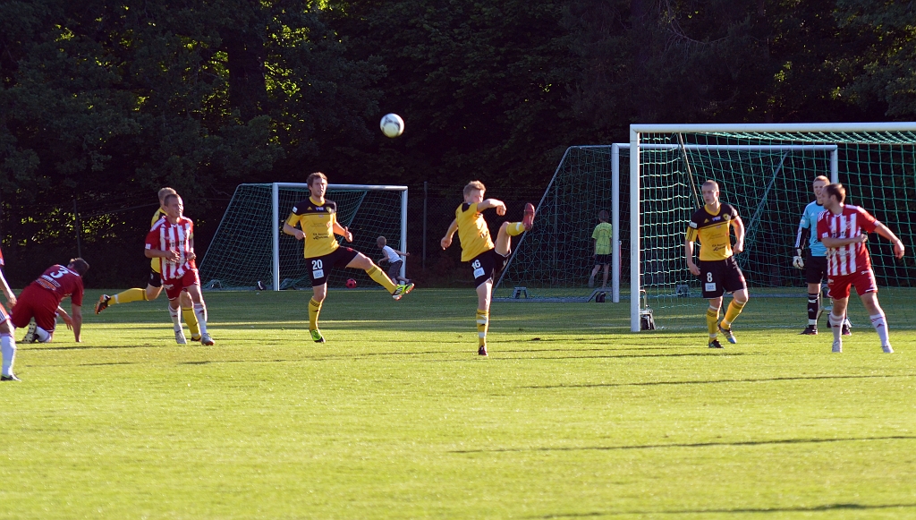 2012_0620_18.JPG - Filip Haglind rensar undan bollen efter en frispark, men i vänsterbildkant har en salaspelare rivits ner och domaren blåser straff