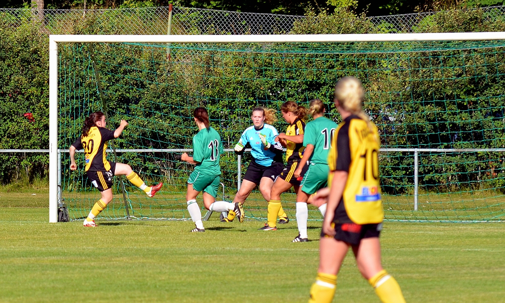 2012_0805_12.JPG - Emma Karlsson rensar undan bollen i ett farligt läge framför målet